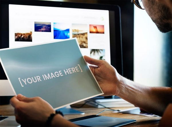 Man Holding Paper or Picture Mockup